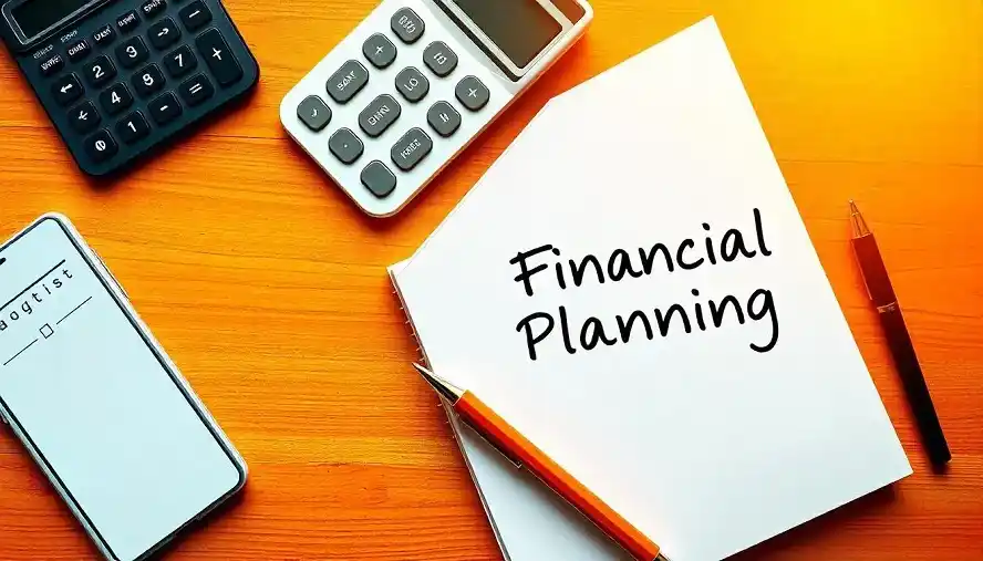 Financial planning essentials including a notebook with financial planning tips, calculator, and smartphone for budget tracking.