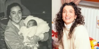 Enrica Cenzatti holding her baby in a heartwarming moment captured in black and white.